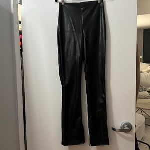Vegan leather flare leggings. New with tags size 4. Dipped waist & split hem